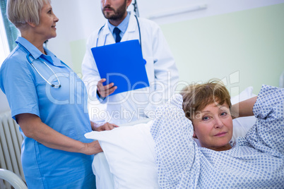 Portrait of smiling patient lying on bed