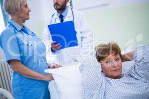 Portrait of smiling patient lying on bed