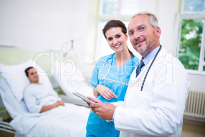 Doctor and nurse discussing on digital tablet