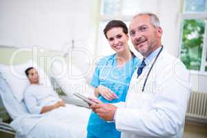 Doctor and nurse discussing on digital tablet