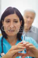 Female doctor holding an injection