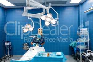 Surgeon placing an oxygen mask on the face of a patient