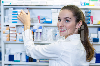Pharmacist checking a medicine in pharmacy