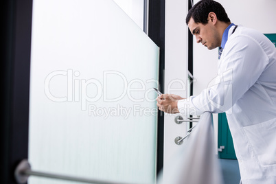 Doctor using mobile phone in corridor