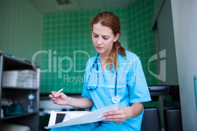 Nurse checking medical report