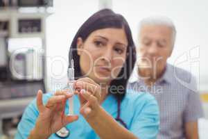 Female doctor holding an injection