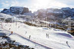 The ski slope and skiers at Passo Groste ski area, Madonna di Campiglio, Italy