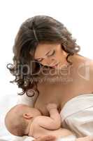 Studio photo of beautiful mother feeding her child