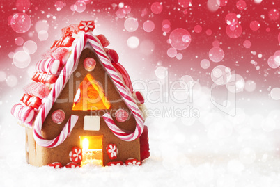 Gingerbread House, Red Background With Bokeh And Snowflakes, Copy Space