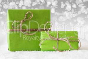 Two Green Gifts On Snow, White Bokeh Effect