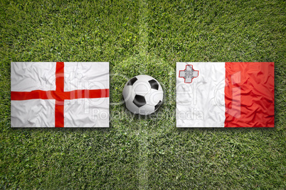 England and Malta flags on soccer field