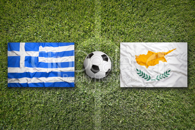 Greece and Cyprus flags on soccer field