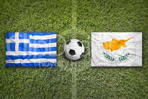 Greece and Cyprus flags on soccer field