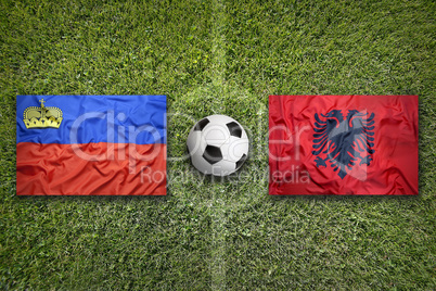 Liechtenstein and Albania flags on soccer field