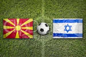 Macedonia and Israel flags on soccer field