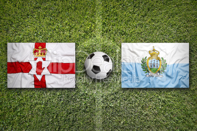 Northern Ireland and San Marino flags on soccer field