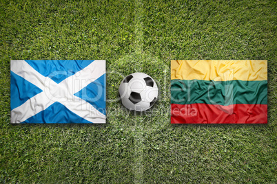 Scotland and Lithuania flags on soccer field