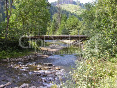 Wooden bridge over mountain river