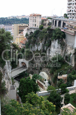 The road passing through a tunnel in the rock. Nice city .