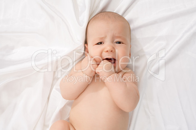 Top view of baby crying while looking at camera