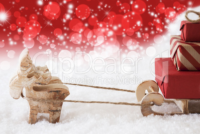 Reindeer With Sled, Copy Space, Red Stars And Bokeh Background