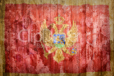 Grunge style of Montenegro flag on a brick wall