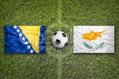 Bosnia and Herzegovina vs. Cyprus flags on soccer field