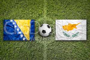 Bosnia and Herzegovina vs. Cyprus flags on soccer field