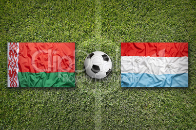 Belarus vs. Luxembourg flags on soccer field