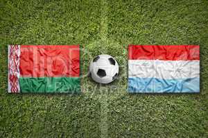Belarus vs. Luxembourg flags on soccer field