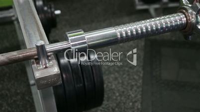 Closeup of female athlete's hand as she grips the weightlifting bar