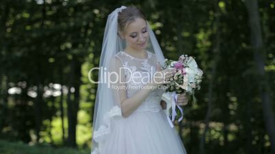 The bride holds a wedding bouquet in hands