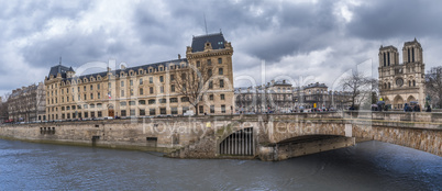Cloudy sky over french buildings and Seine