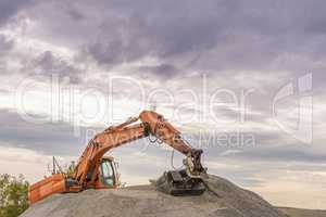 Hydraulic excavator climbed on a ballast pile