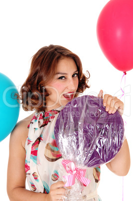 Beautiful woman with lollypop, balloons.