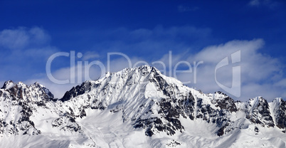 Panoramic view on snowy mountains at sun day