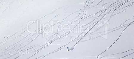 Panoramic view on snowboarder downhill on off piste slope with n