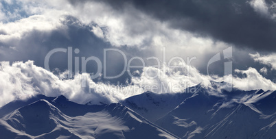 Panoramic view on evening mountains in clouds