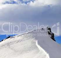 Top of mountains with snow cornice after snowfall