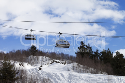 Chair-lift and off-piste slope in ski resort