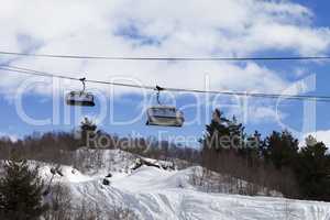 Chair-lift and off-piste slope in ski resort