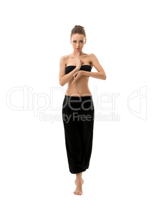 Studio photo of yoga instructor posing at camera