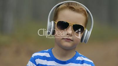 Smiling Little Boy In Headphones Outdoor