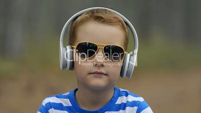 Little Boy Listening To The Music Outdoor