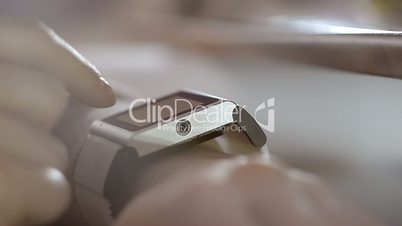 Woman Using Smart Watch At Home In The Evening