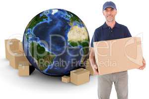 Composite image of happy delivery man holding cardboard box