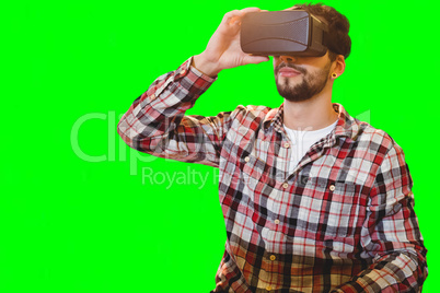 Composite image of casual man man holding virtual glasses on a white background