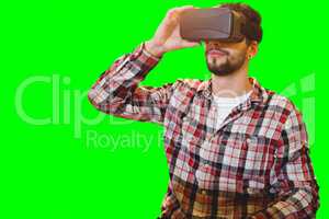 Composite image of casual man man holding virtual glasses on a white background
