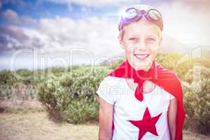 Composite image of little boy pretending to be superhero