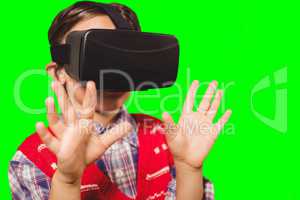 Composite image of boy wearing virtual reality headset